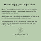 Text on a sage green background reads "How to Enjoy your Cinjo Chime." Instructions advise on chime placement, including air flow and hanging. The Cinjo Handmade logo, featuring a floral design, is at the bottom.