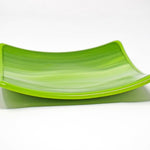 A green square glass dish against a white background. The dish has a light lime green and white striped pattern.