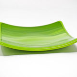 A green square glass dish against a white background. The dish has a light lime green and white striped pattern.