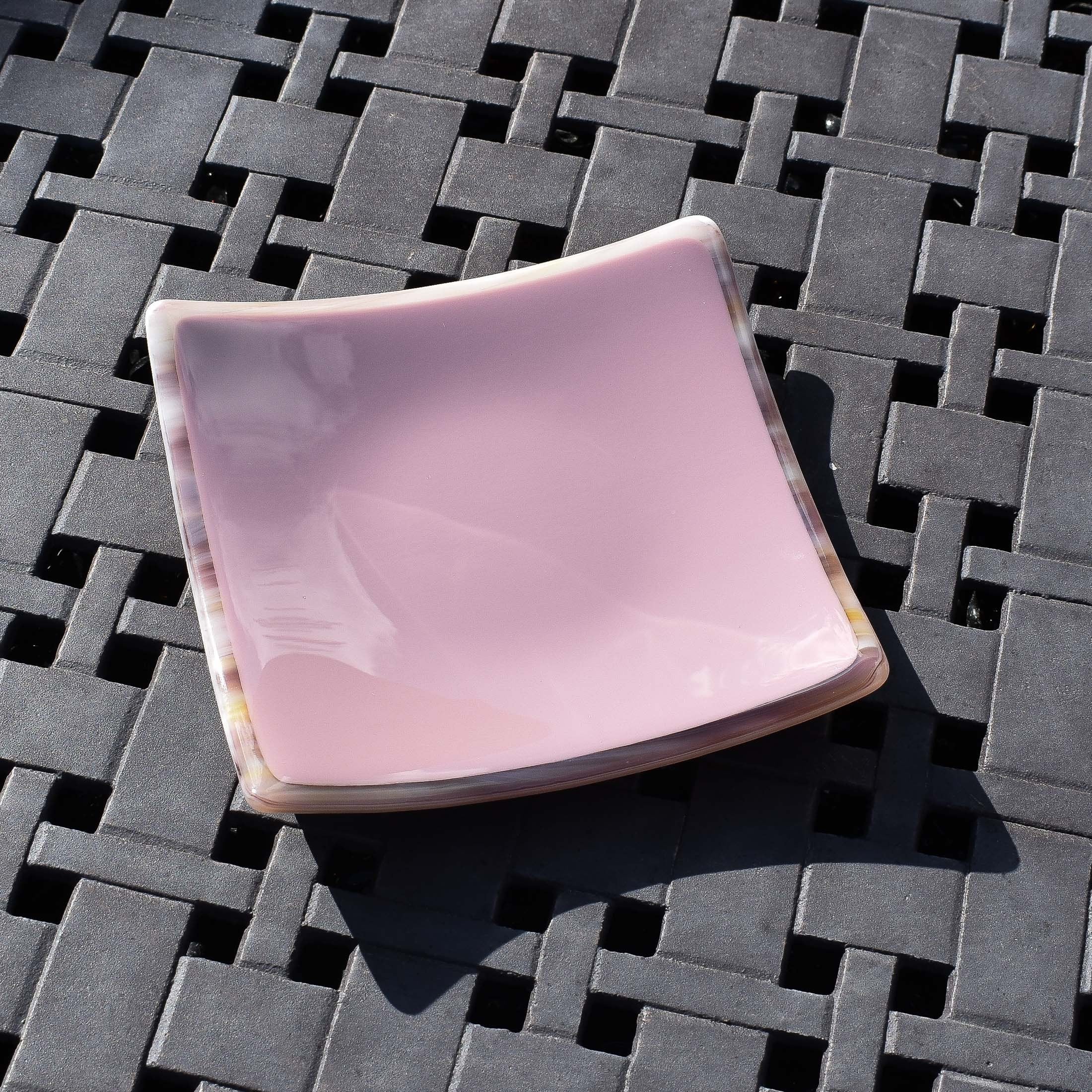 Violet/light purple fused glass dish that is 6&quot; square with multi-color rim and back on a steel grid.