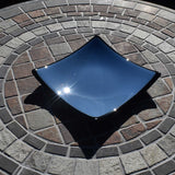 Denim/Chambray Blue fused glass dish with black trim and black bottom. Square with a slight slope at each corner. Sitting on stone table.