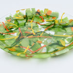 Large round glass tray in lime green, orange, yellow and red.