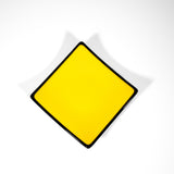 Square kiln-formed glass tray in Sunflower Yellow with black trim, 6 inches with sloped corners.