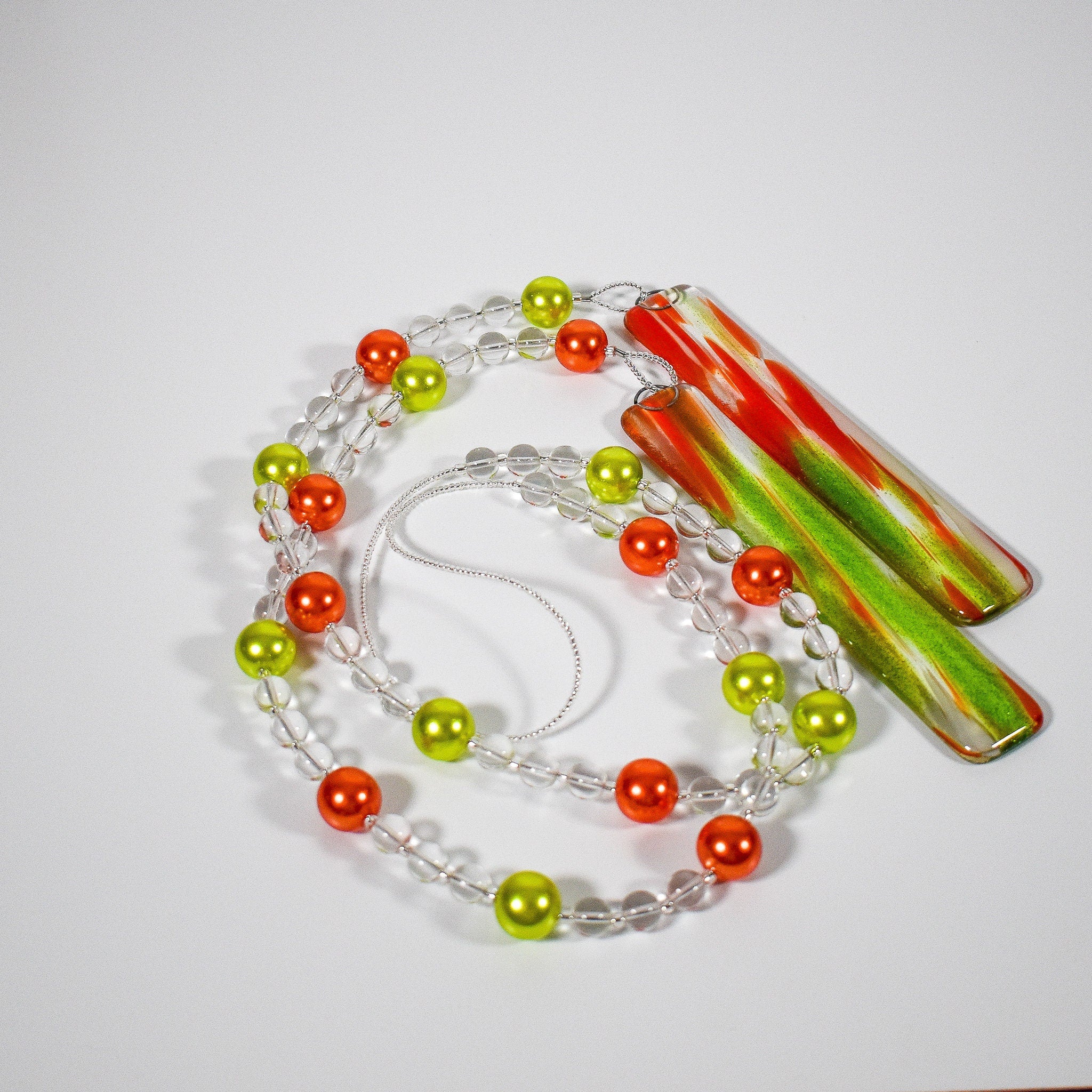 Glass Wind Chime in Summer Colors for Patio, Porch, Garden or Balcony coiled on white background.
