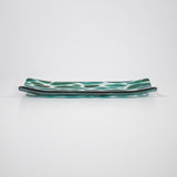 Channel-shaped rectangular serving tray made of clear glass with sparkling green design.