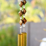 Diamond-shaped Zebra Iron Jasper stones strung with clear glass beads, hanging vertically anchored by two pieces of transparent gold glass