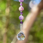 Genuine large and small amethyst stone beads hanging vertically with crystal prism anchor