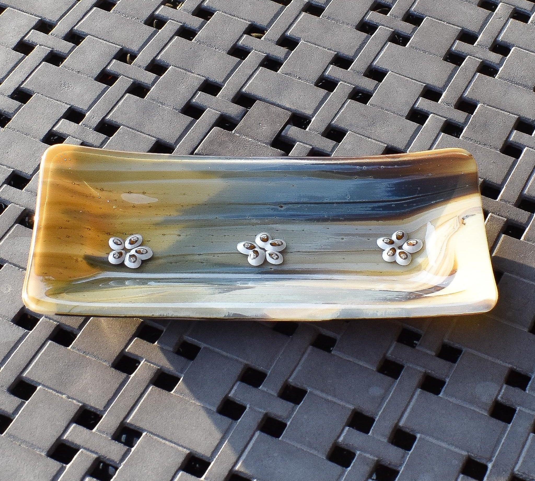 Rectangular glass tray made with streaky glass in gold, cream, tan, brown and gray with floral design