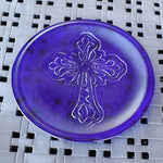 Round glass platter made with dark, transparent iridescent blue glass, embossed with elaborate cross.