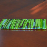 Rectangular glass cheese tray made of strips of lime green, amazon green and navy blue glass.