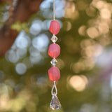 Small handcrafted glass sun catcher with pink beads, clear crystal beads and a crystal raindrop-shaped anchor.