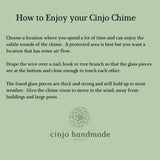 Sage green background with text: "How to Enjoy your Cinjo Chime." Instructions on how to hang a chime, including where to hang it and how to position the glass pieces. The Cinjo Handmade logo is at the bottom.