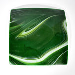 Backside of a square green glass plate showing white swirl design on sparkly aventurine green glass. The plate has a glossy finish and a subtle sparkle. On white background.