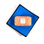 Square fused glass dish with solid blue center, black trim and black base, sitting white surface. A bar of soap is on the tray showing how it would work as a soap dish.