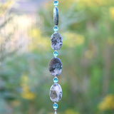 Long hanging sun catcher made of large oval azurite malachite stone beads paired with small turquoise glass beads and a large crystal prism.