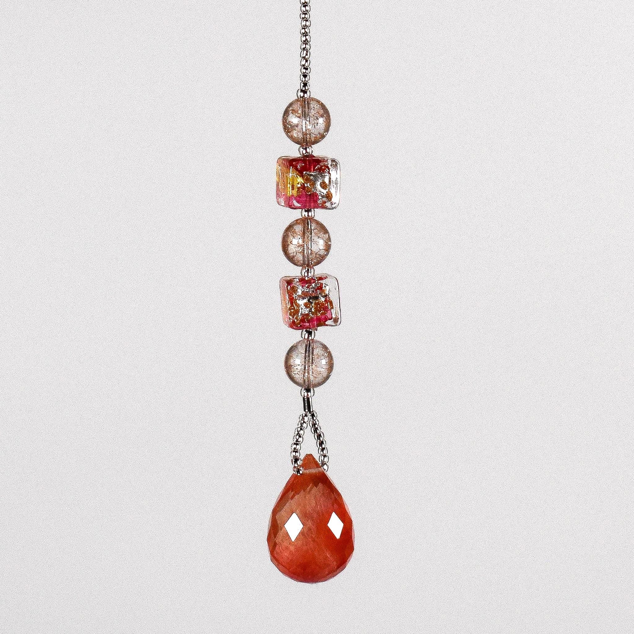 Small pink and gold sun catcher hanging vertically against white background, made with Murano glass beads and a stone pendant.