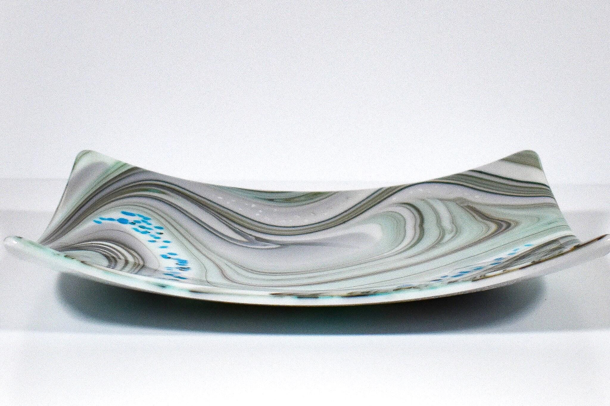 Large 12&quot; glass tray on white background, viewed from the wide edge. Tray is white with swirl pattern in gray, tan and aqua, embellished with flecks of cream and aqua glass. Display as art or use as centerpiece or serving tray.