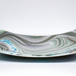 Large 12&quot; glass tray on white background, viewed from the wide edge. Tray is white with swirl pattern in gray, tan and aqua, embellished with flecks of cream and aqua glass. Display as art or use as centerpiece or serving tray.