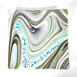 Large 12&quot; glass tray on white surface, from above. Tray is white with swirl pattern in gray, tan and aqua, embellished with flecks of cream and aqua glass. Display as art or use as centerpiece or serving tray.