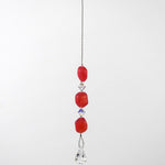 Pink beaded car rearview mirror charm.  The charm features three pink beads interspersed with clear crystal accents and a dangling clear crystal teardrop. The beads are irregular in shape and made of glass.  White background. A silver-lined clasp is used at the top to wrap extra wire around a hook.