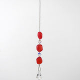 Pink beaded car rearview mirror charm.  The charm features three pink beads interspersed with clear crystal accents and a dangling clear crystal teardrop. The beads are irregular in shape and made of glass.  White background. A silver-lined clasp is used at the top to wrap extra wire around a hook.