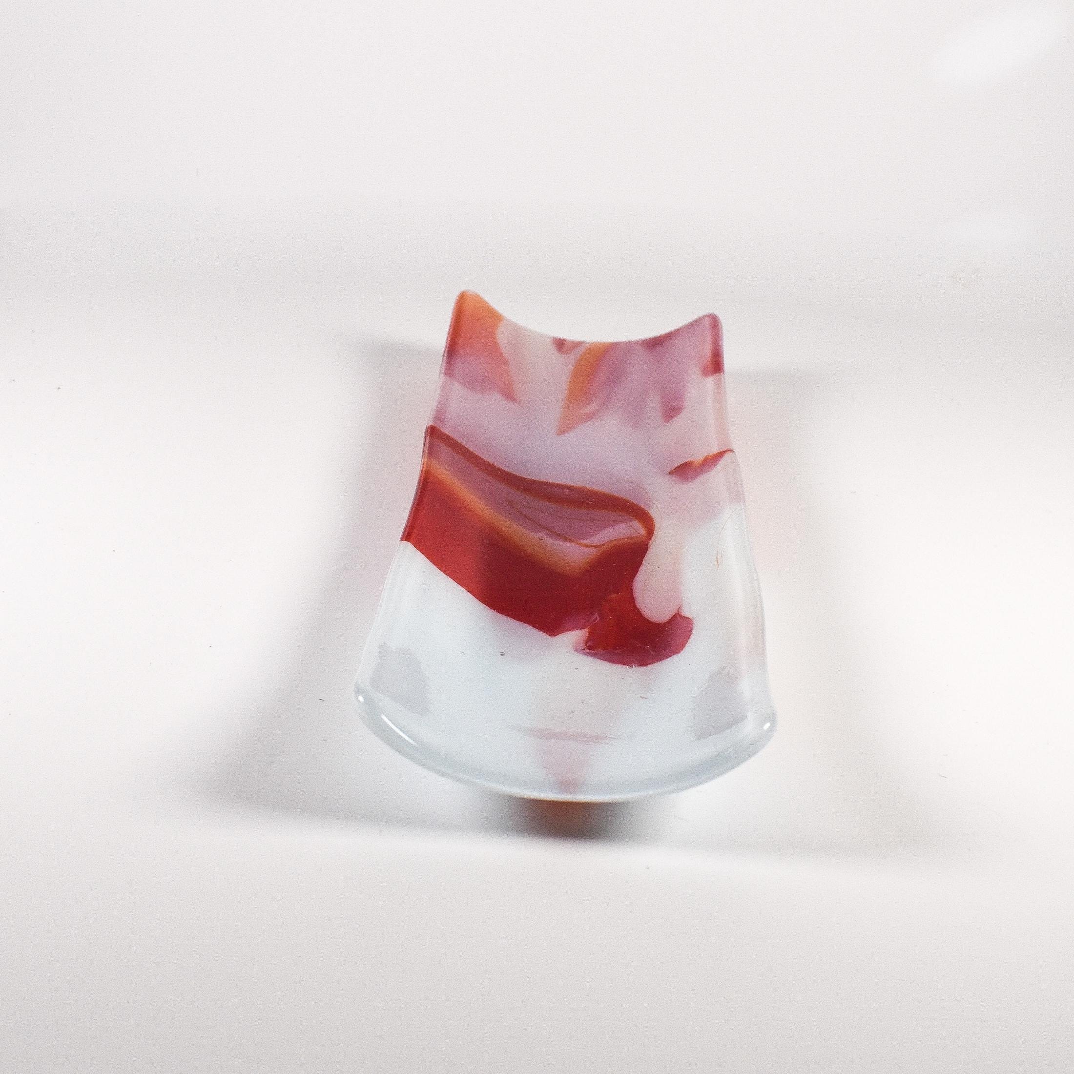 End view in softer lighting showing the raised sides and the red swirl inside the channel.