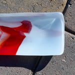 Close-up of one end on pavers showing soft white/blush tones with orange accents.