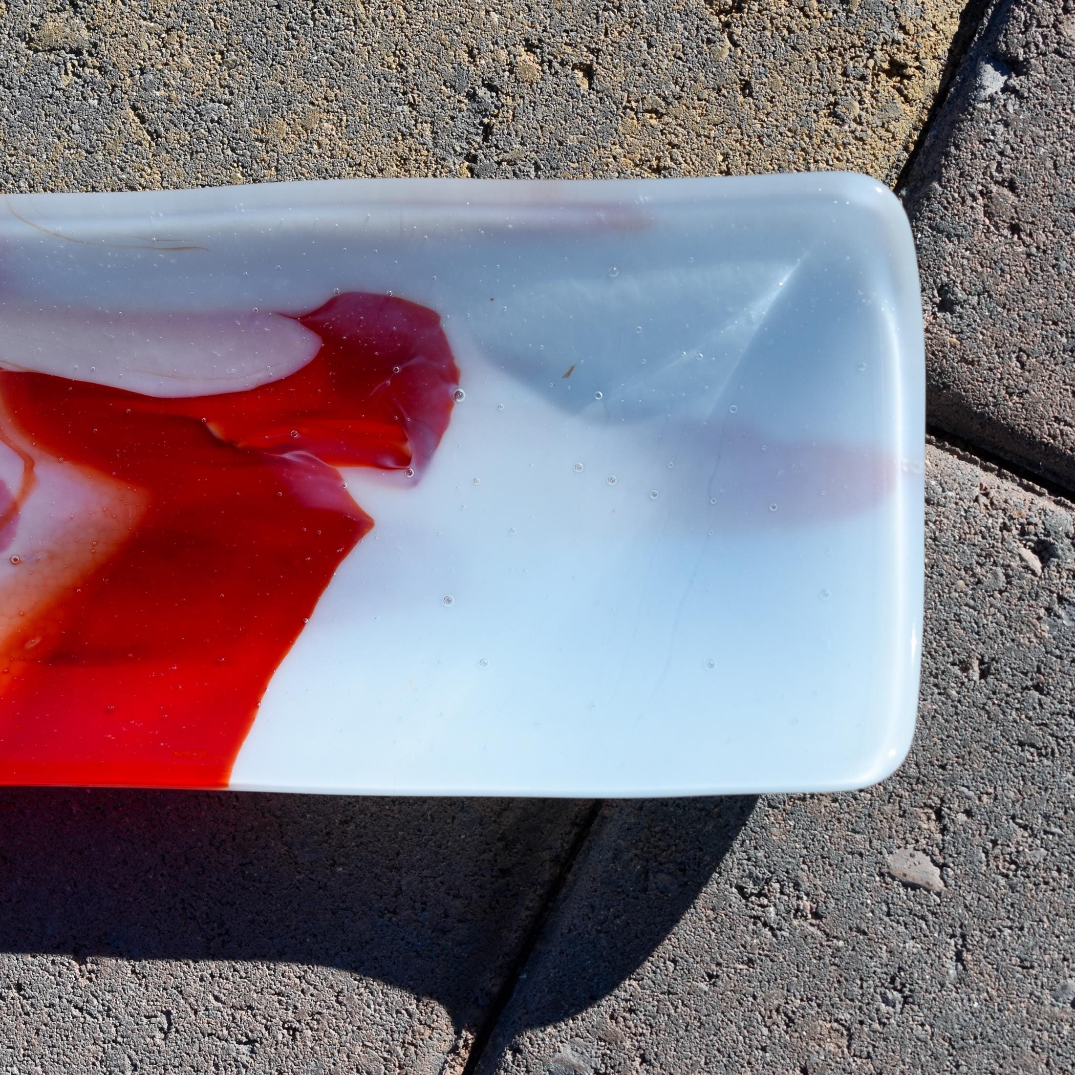 Close-up of one end on pavers showing soft white/blush tones with orange accents.