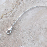 Close up photo of lobster clasp used in Cinjo Handmade small sun catchers.