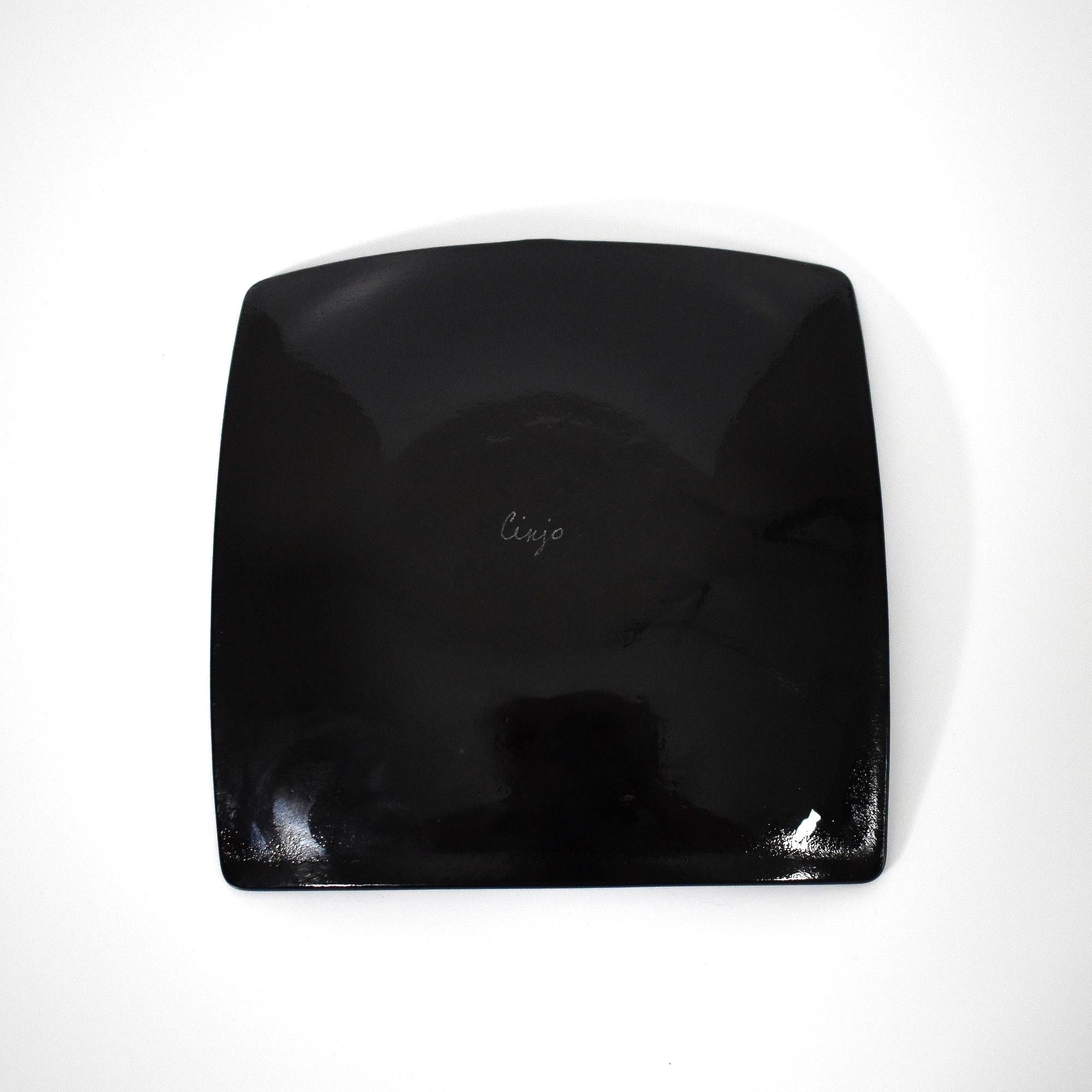 The black underside of square shaped fused glass tray.