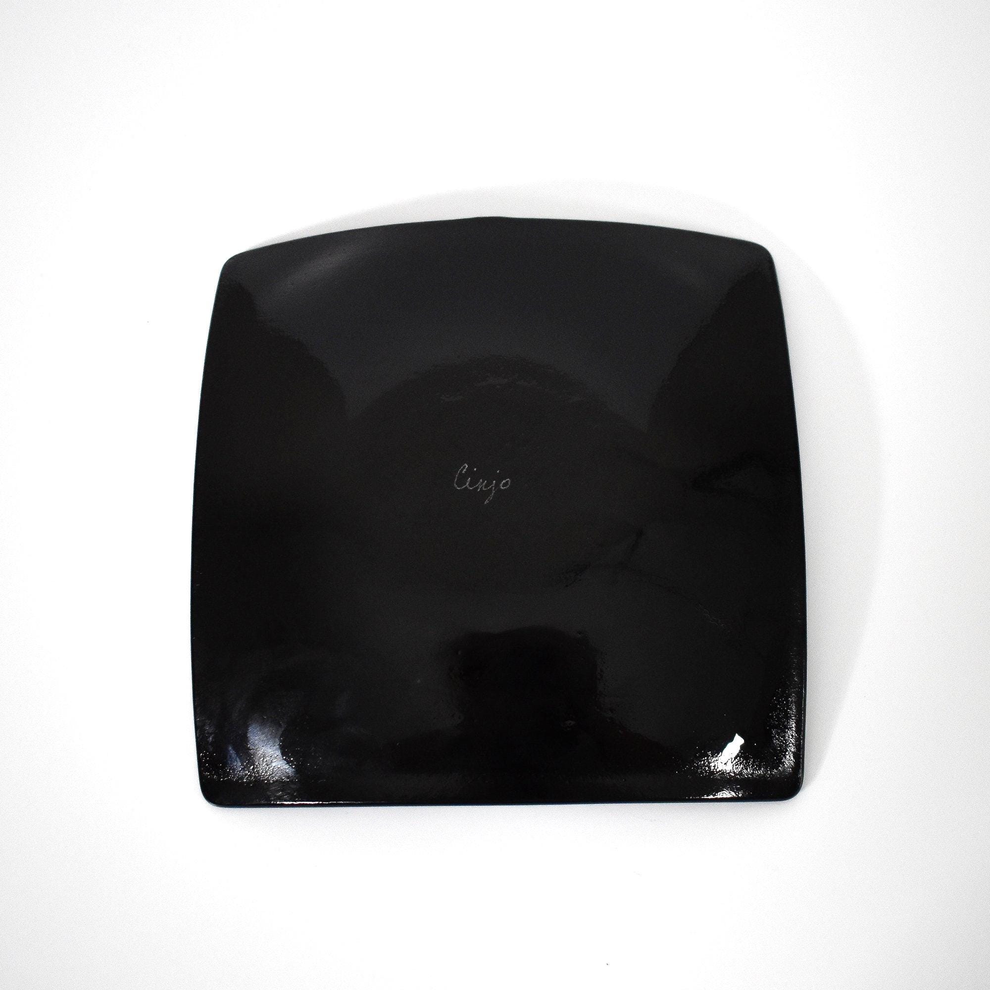 The black underside of square shaped fused glass tray.