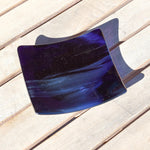 Deep transparent purple and white streaky glass formed into a 6" square slightly sloped dish.