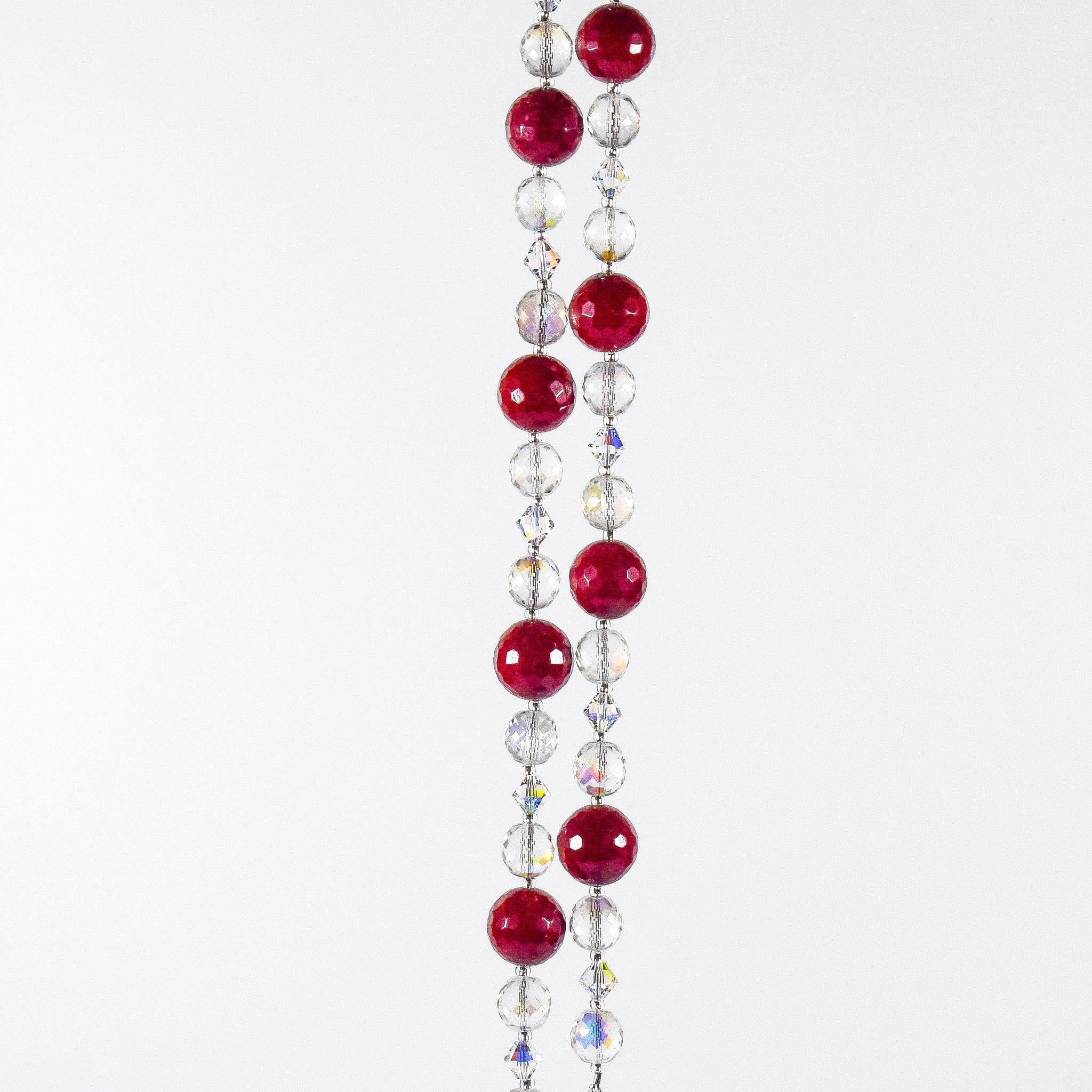 Large cranberry red jade stones beaded with glass and crystals, hanging vertically against white background.