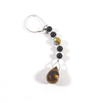 A silver chain with black and gold beads and a teardrop-shaped tiger's eye stone pendant.
