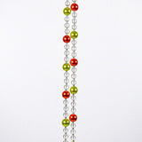 Two strands of clear beads with alternating orange and green beads hanging vertically against white background.