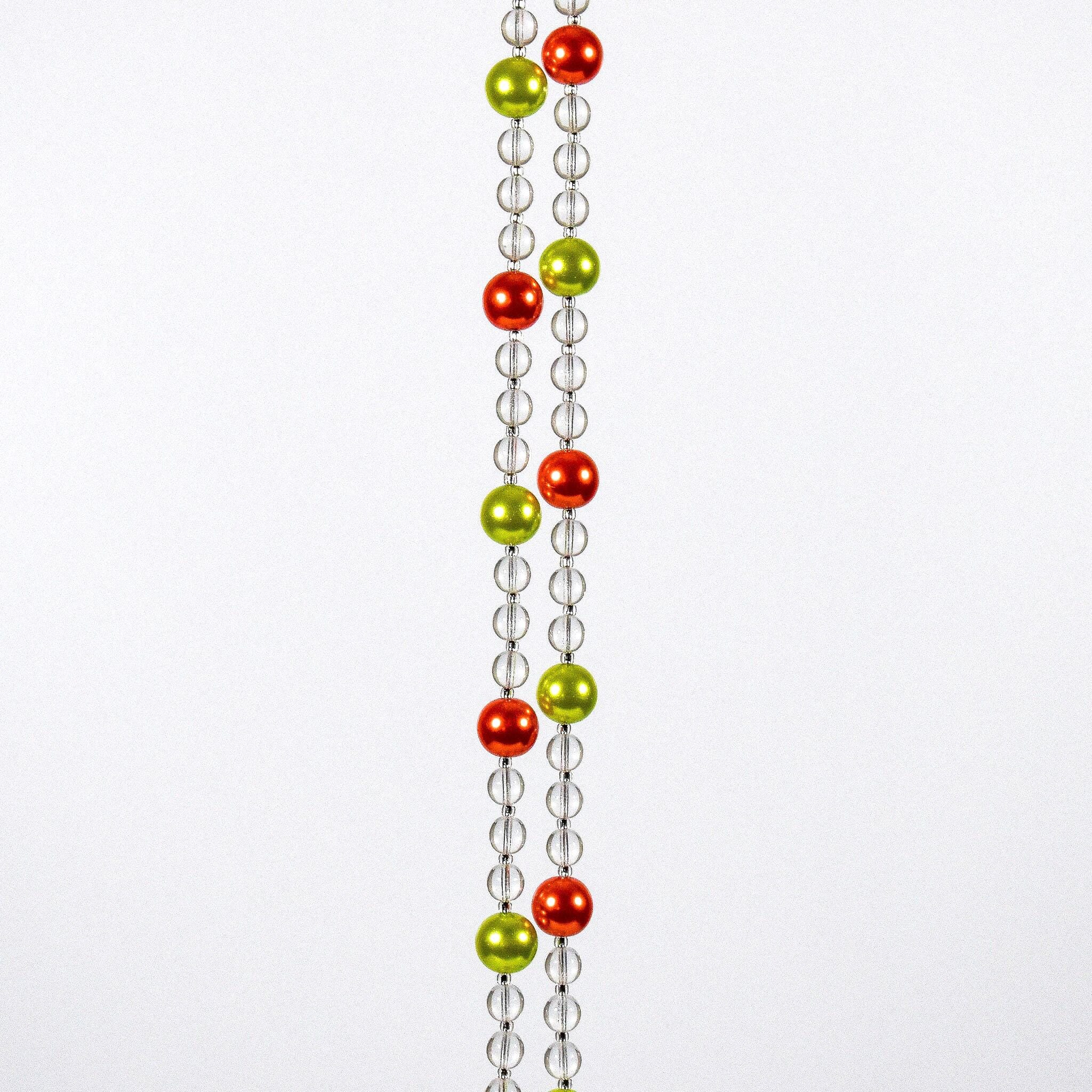 Two strands of clear beads with alternating orange and green beads hanging vertically against white background.