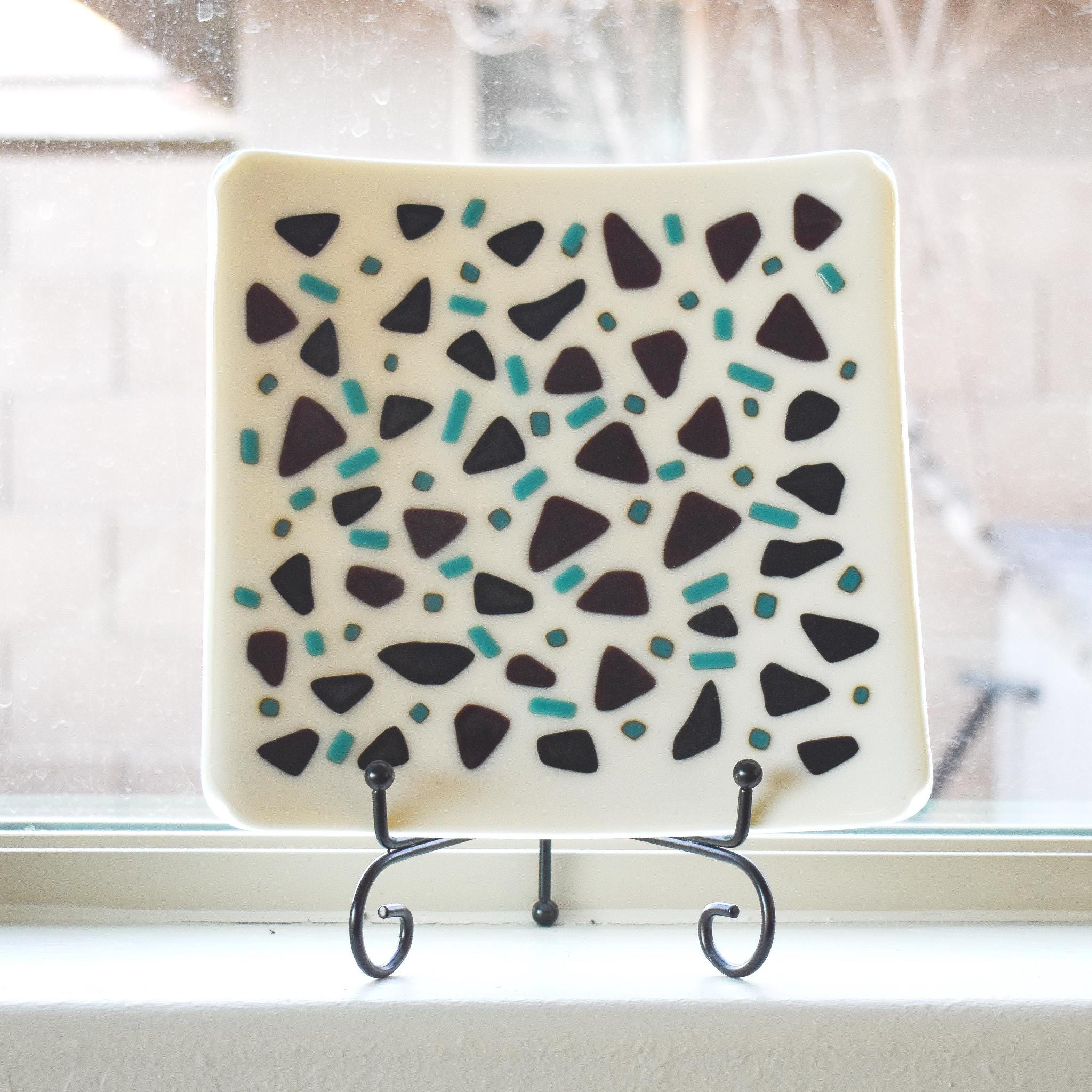 Square kiln formed glass tray in vanilla cream with accents of black and peacock green.