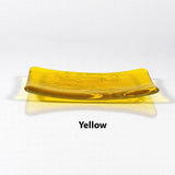 Glass soap dish in transparent yellow glass with swimming fish design.