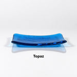 Glass soap dish in transparent Topaz Blue glass with swimming fish design.