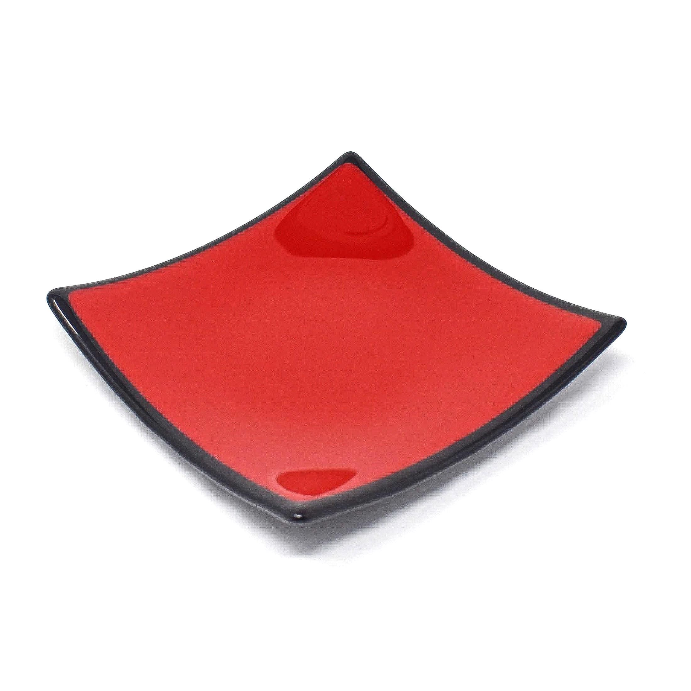 A red square plate with a black rim. The plate is glossy and has a slight curve to the edges. White background.