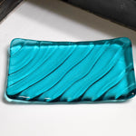 Glass soap dish with wave pattern in Caribbean blue.