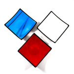Top view of 3 different colored 6" fused glass square trays: Blue with Black Streaky, Red and White.