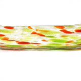 Rectangular glass serving dish with a clear base. The dish features a decorative pattern of orange and green splotches. The colors are distributed across the surface, creating a speckled effect. The edges are slightly curved into a channel shape.