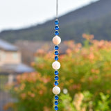 Quartz and Aqua Glass Sun catcher hanging vertically.
