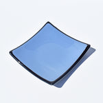 Denim blue fused glass with black trim on white background