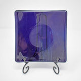 Handmade deep purple fused glass dish on stand with white background